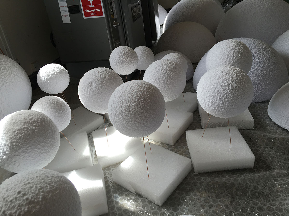Giant snow flocked artificial snowballs by Snow Business in preparation for a Christmas Window Display